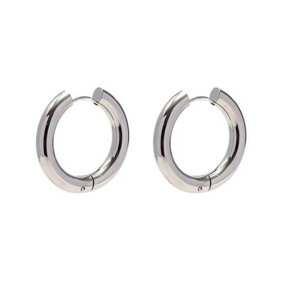 Indulge in the timeless elegance of our Celine Silver Hoop Earrings. Classic and must-have, these earrings are the perfect addition to any outfit. Elevate your style and make a statement with these exquisite hoops. You won&