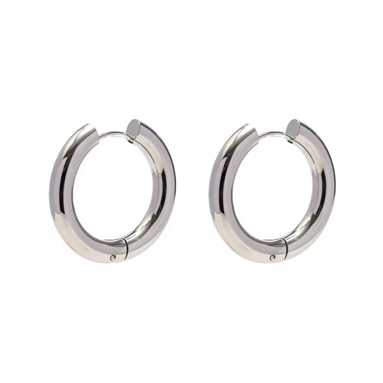 Indulge in the timeless elegance of our Celine Silver Hoop Earrings. Classic and must-have, these earrings are the perfect addition to any outfit. Elevate your style and make a statement with these exquisite hoops. You won&