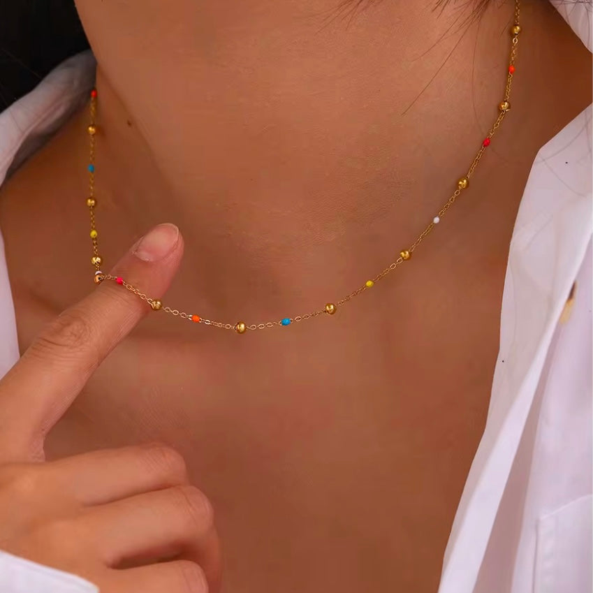 Add a pop of color to your summer look with our super dainty Colorful Enamel Small Beads Chain! Not only does it scream summer, but it&