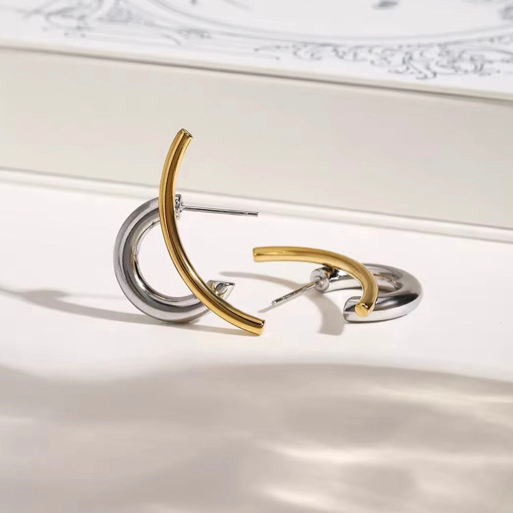  Flat lay of Zaria sculptural hoop earrings in gold and silver from ELSSIZ
