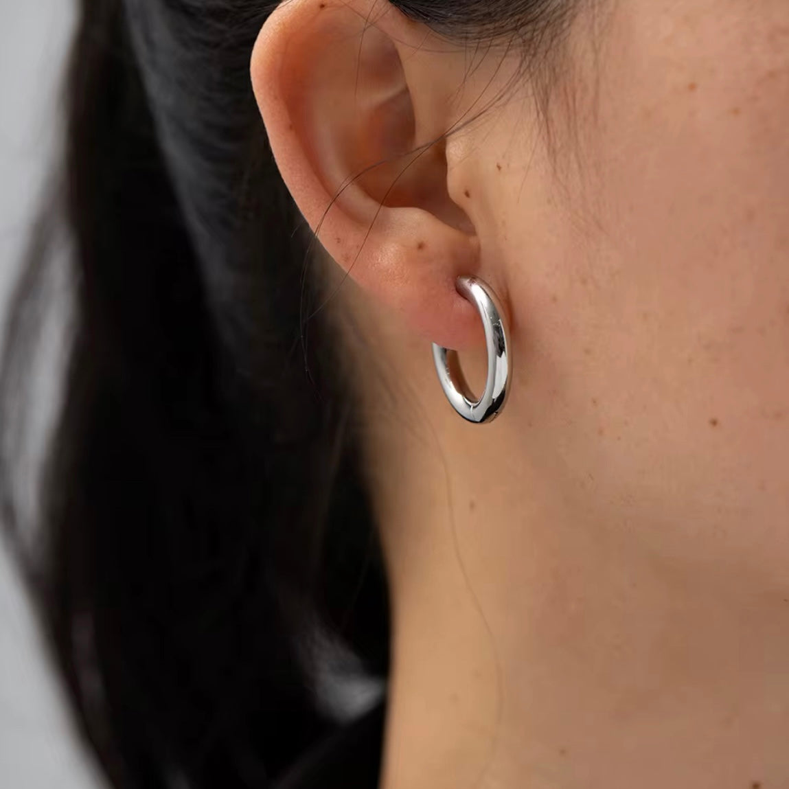 Indulge in the timeless elegance of our Celine Silver Hoop Earrings. Classic and must-have, these earrings are the perfect addition to any outfit. Elevate your style and make a statement with these exquisite hoops. You won&