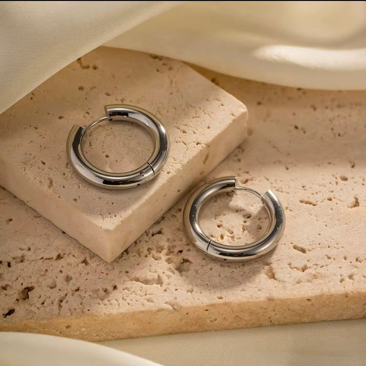 Indulge in the timeless elegance of our Celine Silver Hoop Earrings. Classic and must-have, these earrings are the perfect addition to any outfit. Elevate your style and make a statement with these exquisite hoops. You won&