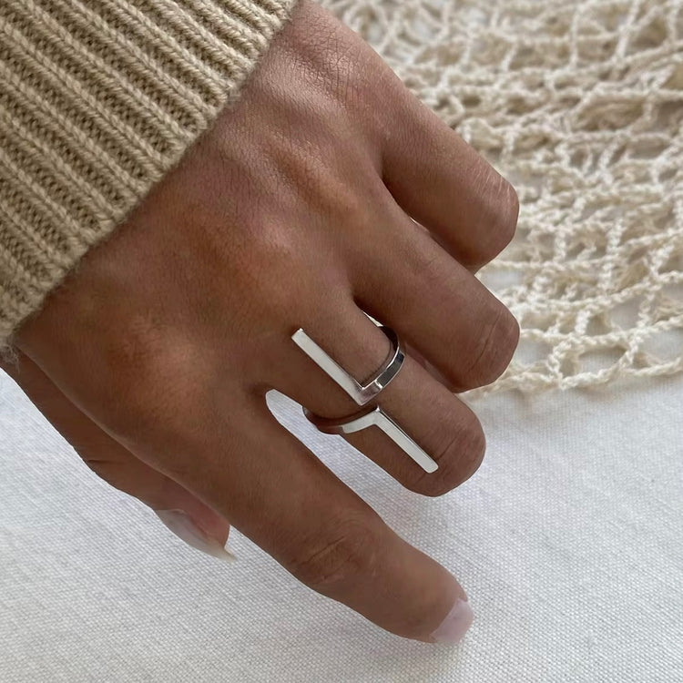 Inspire your style with our Tetris Open Ring! Embrace the geometric, unique design of this minimalistic piece. Stand out from the crowd with a touch of modernity and sophistication. Elevate any outfit and make a statement with this one-of-a-kind ring.

Metal:&nbsp; Stainless Steel

Hypoallergenic &amp; Water Resistant

Size: Adjustable Fits size 8/9