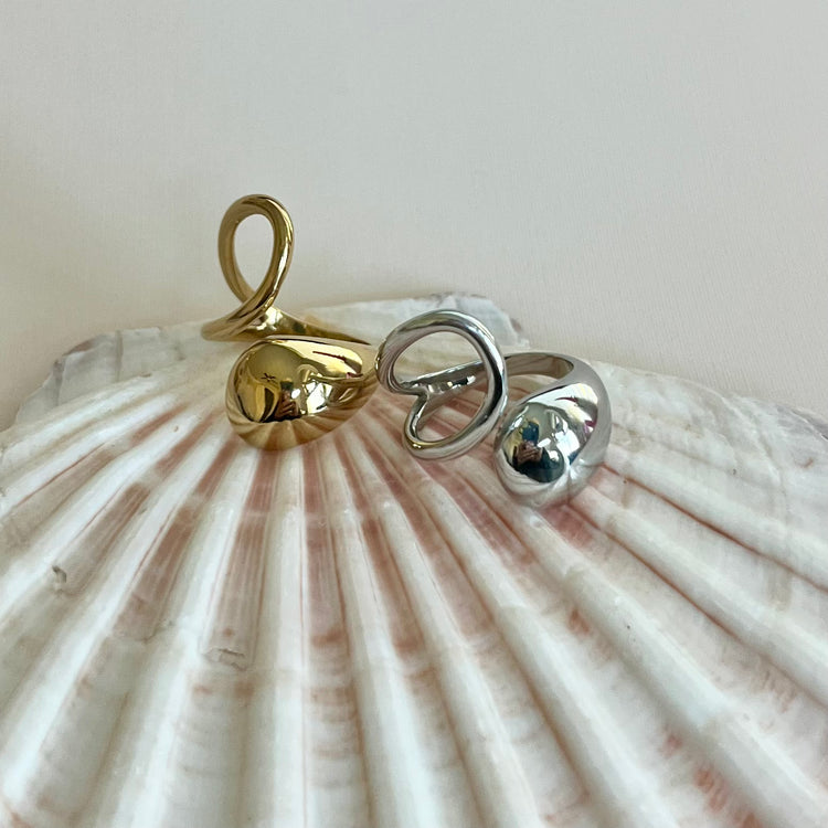 Experience the art of modern luxury with our Galiya Open Ring. The abstract open design creates a sophisticated and exclusive statement piece, sure to start conversations. Elevate your style and be the center of attention with this uniquely elegant ring.

Fits SIZE - 6/7/8 Adjustable

Stainless Steel 18K Gold PVD Plated - Made to last!

Hypoallergenic, Tarnish free 