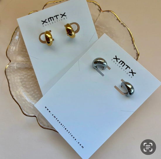 Gold and silver earrings on ELSSIZ Collection cards with a beige background