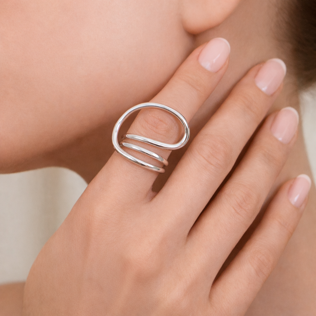 Silver Sam adjustable spiral ring worn on finger, bold modern sculptural statement ring.