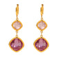Gold earrings with purple gemstones on a white background