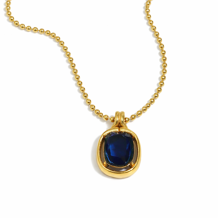 Noelle blue stone pendant necklace in 18K gold plated stainless steel with beaded chain on white background