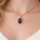 Noelle 18K gold blue stone pendant necklace worn on model showing adjustable beaded chain length