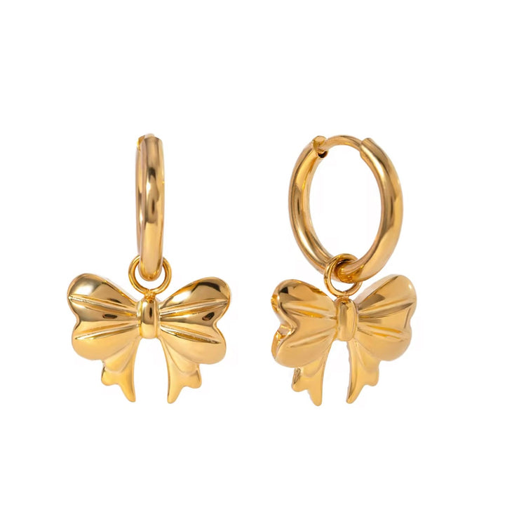 Embrace the latest trend with our must-have Bow Huggies Earrings. These cute accessories add a touch of charm to any outfit. Expertly crafted and designed to hug the ear, they are the perfect addition to your jewelry collection.

Made to last!&nbsp;Tarnish and Water Resistant, Beach &amp; Shower friendly, Hypoallergenic

.82" total length from the hoop the the tip of the bow

18K Gold Plated over 316L Stainless Steel base