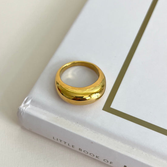 The Remi Ring boasts a unique arc shape, making it a bold statement piece for any outfit. Crafted with expert precision, this ring offers a sleek and modern design for those seeking a sophisticated accessory.&nbsp;

Stainless Steel 18K Gold PVD Plated - Made to last!

Hypoallergenic, Tarnish free Beach &amp; Pool Friendly