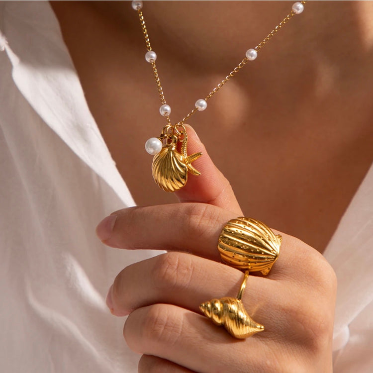 Discover the perfect accessory for any beach lover with our Under the Sea Necklace. This beachy necklace will transport you to forever summer vibes with its charming shell, starfish, and pearl charms. Embrace your inner mermaid and add a touch of whimsy to any outfit.
.
Made to last! Tarnish and Water Resistant, Hypoallergenic
16" long +2" ext
Closure : Lobster Clasp
18k Gold PVD Plated over 316L Stainless Steel base