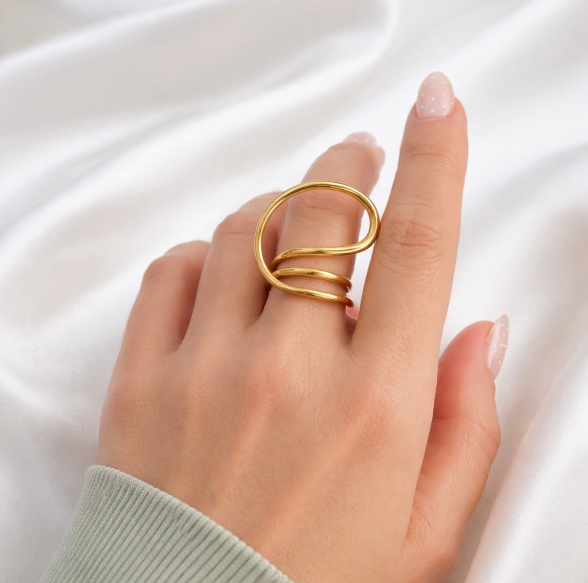Gold Sam adjustable spiral ring on hand, modern open wrap statement ring fits sizes 7 to 8