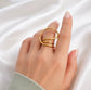 Gold Sam adjustable spiral ring on hand, modern open wrap statement ring fits sizes 7 to 8