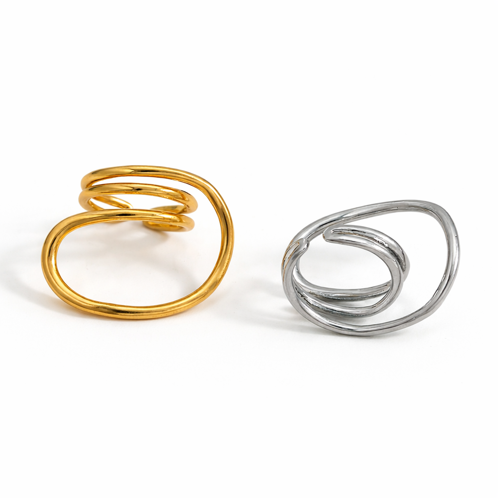 Gold and silver Sam adjustable spiral ring on white background, modern open wrap statement ring.