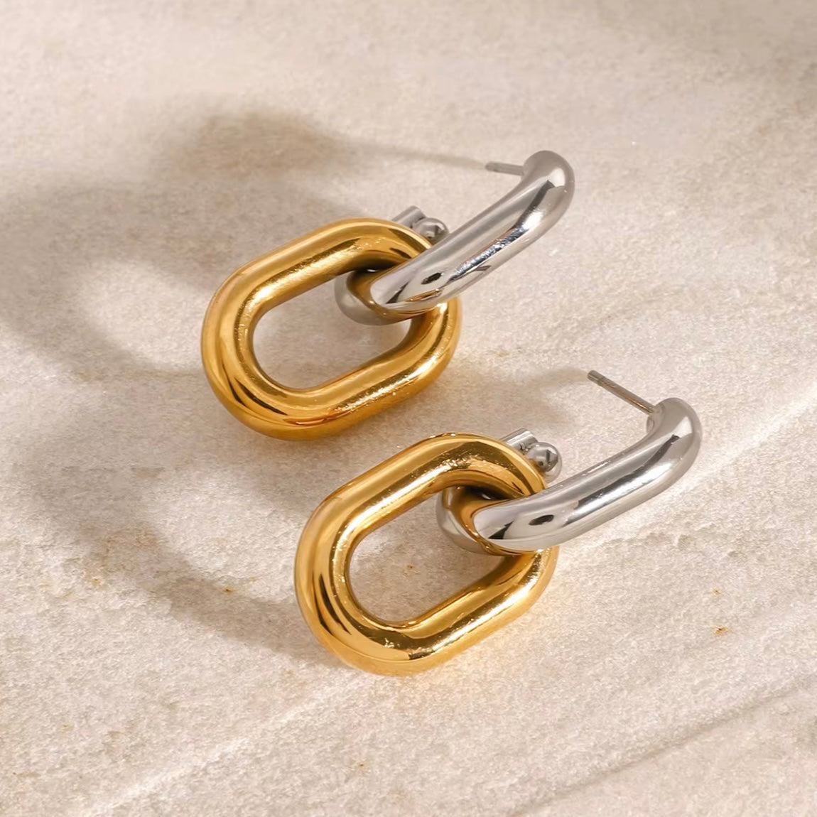 Introducing Erina Two Tone Chain Hoop Earrings - a must-have for any collection. These elegant earrings feature a trendy two-tone design and are sure to elevate any outfit. A staple for every fashion-forward individual.

Made to last!&nbsp;Tarnish and Water Resistant, Beach & Shower friendly, Hypoallergenic




18K Gold Plated over 316L Stainless Steel base