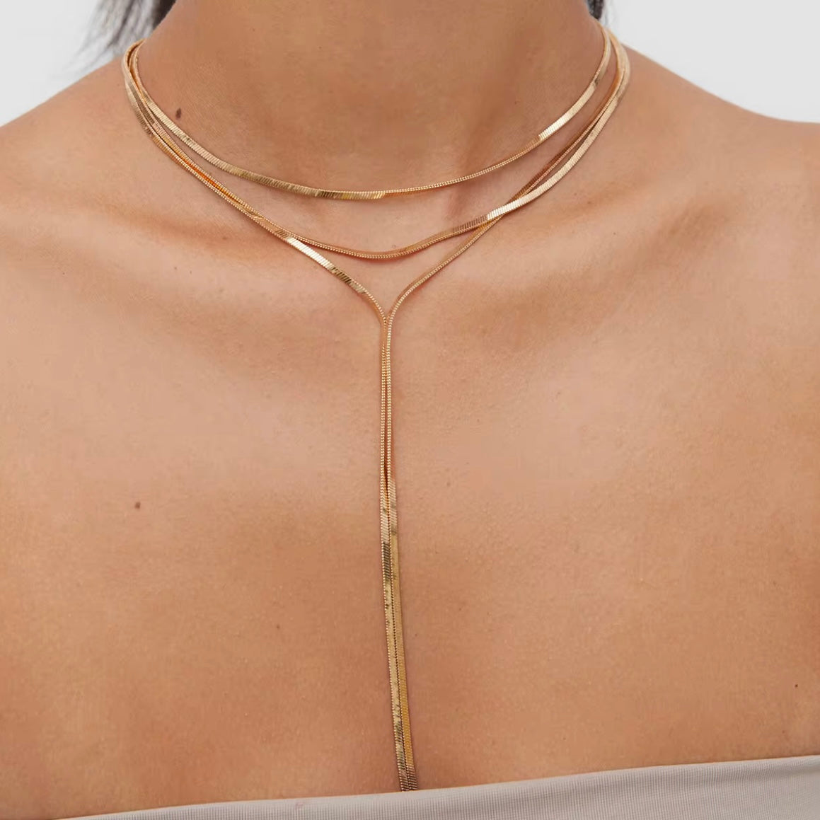 Gold Lonnie Y Snake Necklace with adjustable Y-drop silhouette on white background
