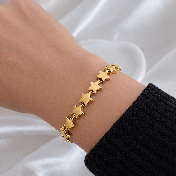 Gold stars bracelet on wrist featuring linked star design, non tarnish stainless steel jewelry by ELSSIZ
