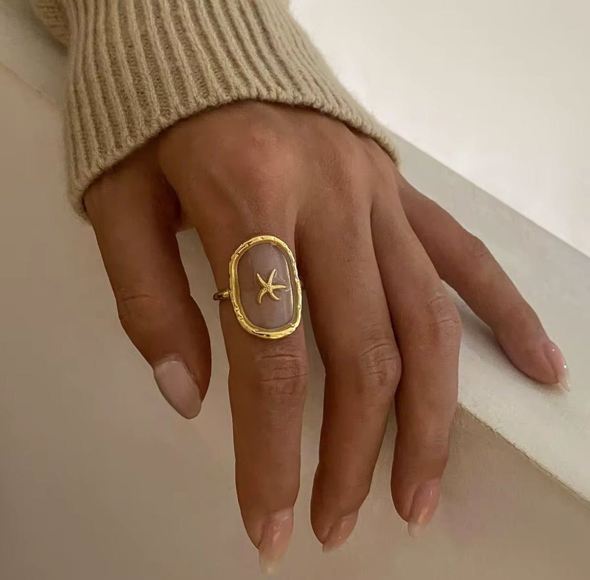 This See Through Starfish Ring is perfect for adding a touch of beach vibes to your summer wardrobe. Its unique design allows for a see through effect, making it a truly unique piece. Get ready to stand out with this one of a kind ring. Made for the summer sun and sand.

Fits SIZE - 7/ Open size

Stainless Steel 18K Gold PVD Plated - Made to last!

Hypoallergenic, Tarnish free&nbsp;