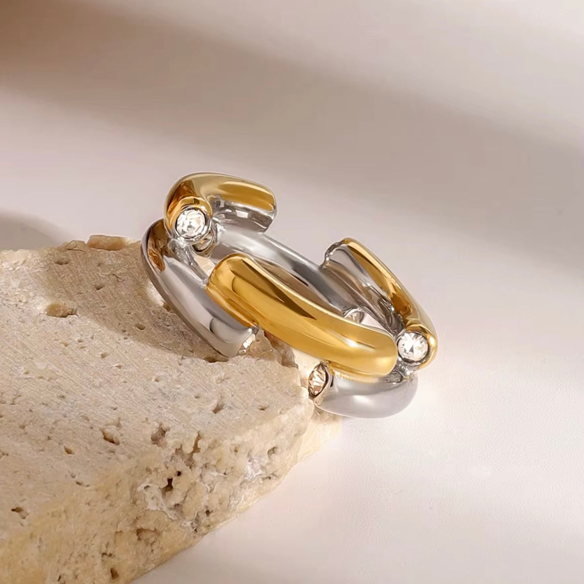 The Angelika Open Band Ring is a stunning embodiment of modern elegance and sophistication. With a seamless blend of gold and silver tones, this ring exudes luxury and versatility. Made with a durable and comfortable design, it is the perfect statement piece for any occasion.

Metal:&nbsp; Stainless Steel

Hypoallergenic &amp; Water Resistant

Size: 7 only