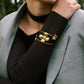 Flower & Butterflies Bangle Bracelet ELSSIZ model is wearing it over black sweater