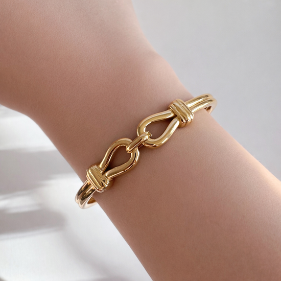 Gold interlock bangle bracelet worn on wrist – minimalist non-tarnish jewelry by ELSSIZ