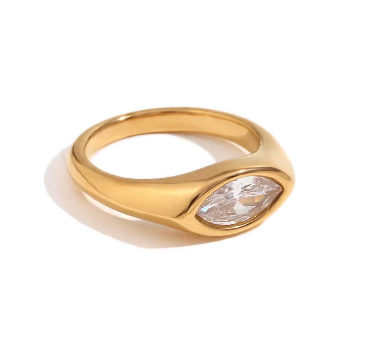 Close-up of Luma gold marquise cut clear stone ring on white background, non tarnish modern ring