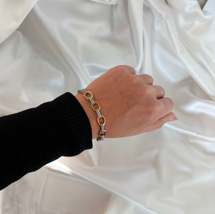 Model wearing the Madison two-tone link bracelet featuring mixed gold and silver stainless steel links, a waterproof and non-tarnish everyday bracelet by ELSSIZ.