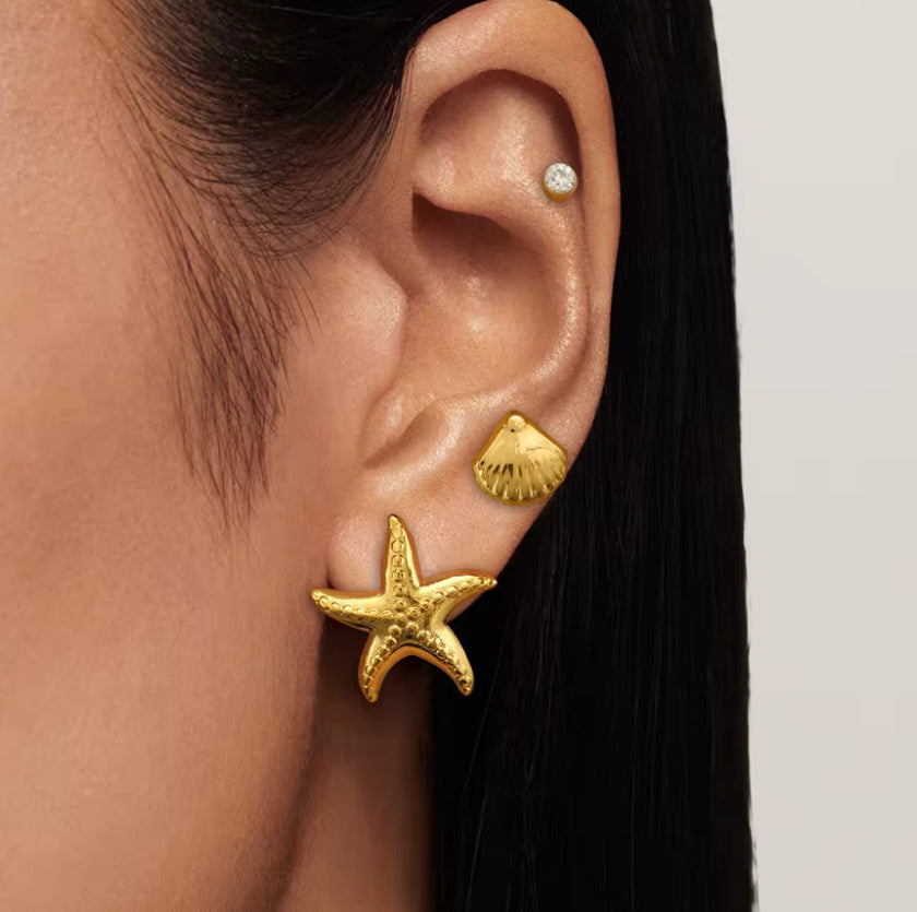Complement your summer style with these charming Starfish Stud Earrings. Perfect for everyday wear or your next beach vacation, these earrings will add a touch of whimsy and ocean vibes to any outfit. Embrace the carefree spirit of summer with these must-have accessories!

 

1" long x 1" wide

18K Gold Plated over 316L Stainless 

Hypoallergenic, Water Resistant, Beach, Shower, Gym friendly. Made to last.

 

 