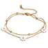 Add a touch of whimsy to your outfit with our Mother of Pearl Flowers Anklet. Delicate and dainty, this anklet features pretty, natural shell flowers that will elevate any look. Perfect for those who want to add a fun and playful touch to their style.

&nbsp;

This piece is made to last, hypoallergenic anti tarnish &amp; water resistant&nbsp;

316L Stainless Steel 18K Gold Plated

8.5 inches long +2 inches ext