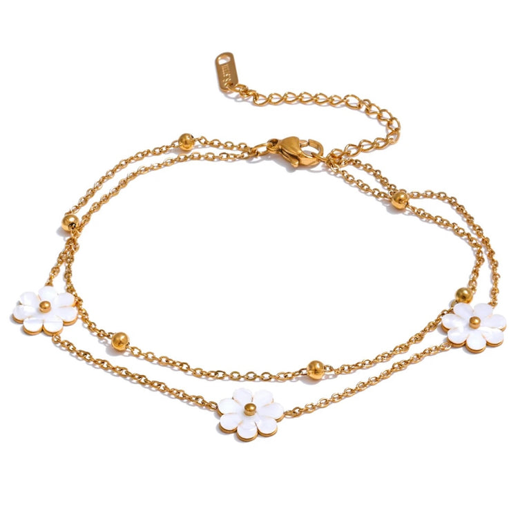 Add a touch of whimsy to your outfit with our Mother of Pearl Flowers Anklet. Delicate and dainty, this anklet features pretty, natural shell flowers that will elevate any look. Perfect for those who want to add a fun and playful touch to their style.

&nbsp;

This piece is made to last, hypoallergenic anti tarnish &amp; water resistant&nbsp;

316L Stainless Steel 18K Gold Plated

8.5 inches long +2 inches ext