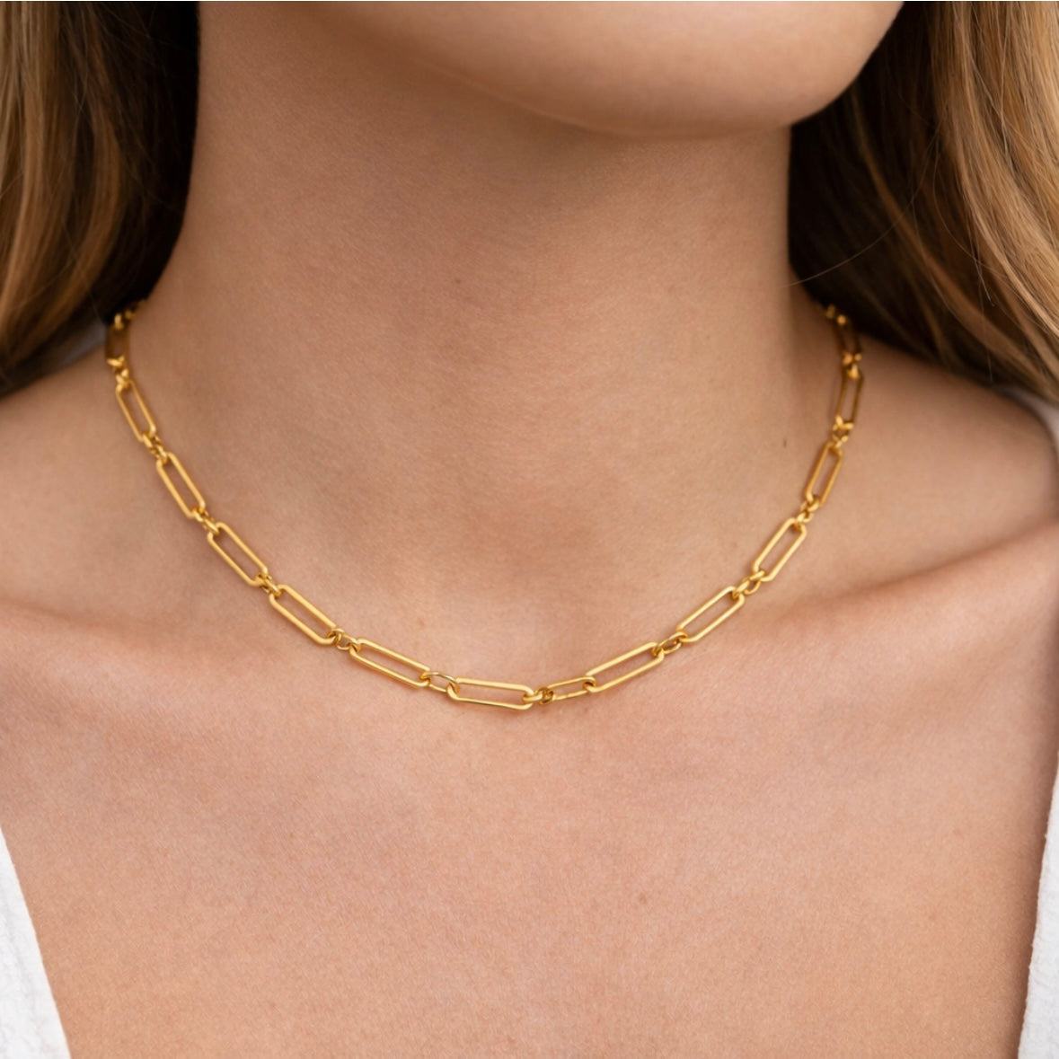 Model wearing the Sorelle short gold paperclip chain necklace designed for everyday layering.