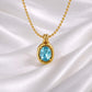 Close-up of Skye light aqua oval gemstone pendant necklace in 18K gold plated stainless steel on white silk background