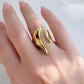Gold open-end statement ring with organic molten design worn on hand, made of polished stainless steel, non-tarnish and waterproof by ELSSIZ