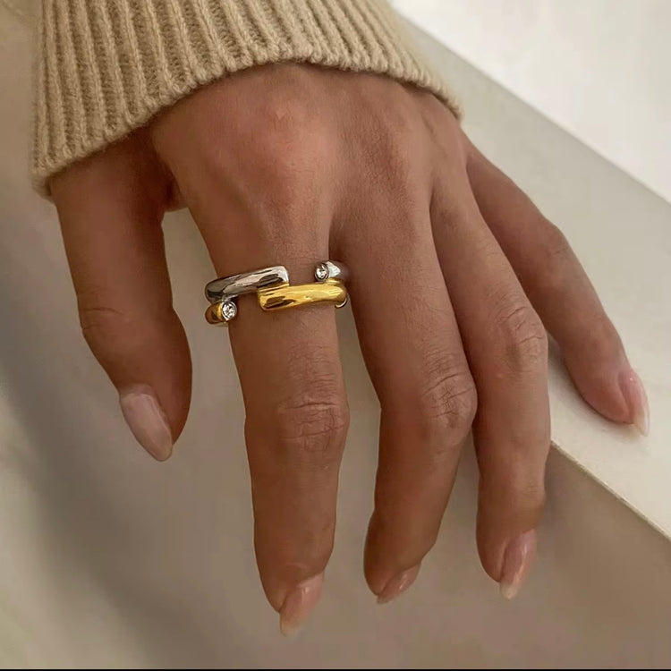 The Angelika Open Band Ring is a stunning embodiment of modern elegance and sophistication. With a seamless blend of gold and silver tones, this ring exudes luxury and versatility. Made with a durable and comfortable design, it is the perfect statement piece for any occasion.

Metal:&nbsp; Stainless Steel

Hypoallergenic &amp; Water Resistant

Size: 7 only