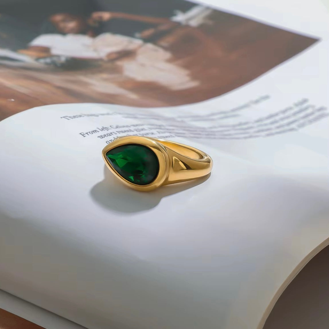 Expertly designed, the Ivy Ring features a stunning tear-shaped deep green gemstone that adds a modern statement to any ensemble. Crafted with precision and style, this accessory exudes elegance and sophistication, making it a must-have for any fashion-forward individual.&nbsp;

Green Zircon

Stainless Steel 18K Gold PVD Plated - Made to last!

Hypoallergenic, Tarnish free Beach &amp; Pool Friendly