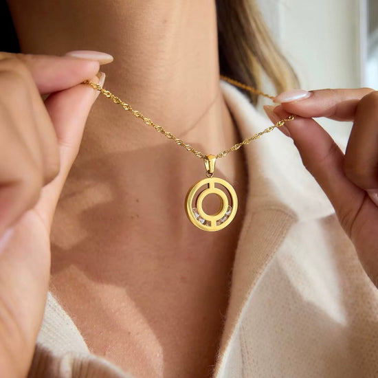 Woman wearing Stephanie gold circle pendant necklace with twisted rope chain waterproof stainless steel jewelry