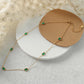Delicate waterproof gold necklace with green accents