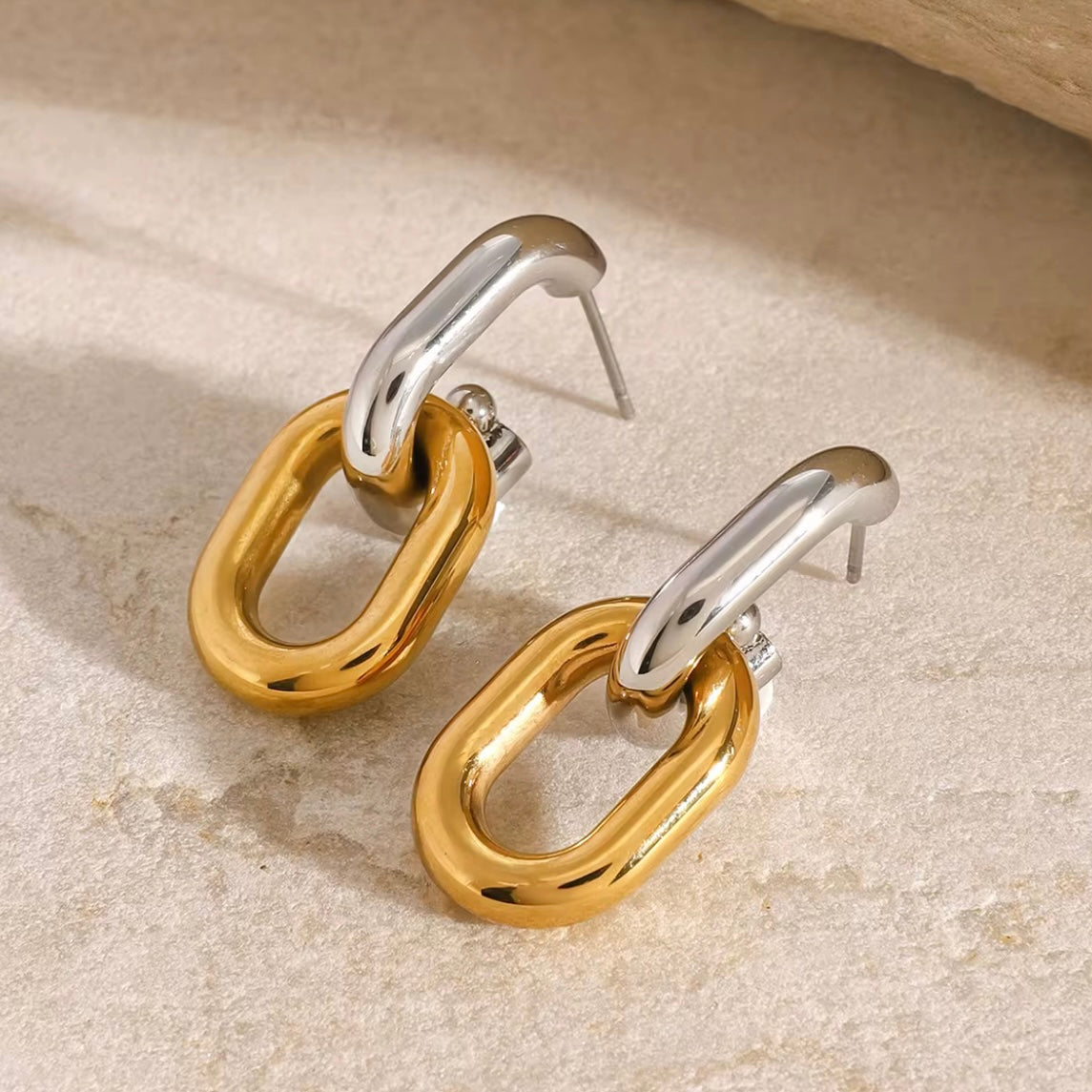 Introducing Erina Two Tone Chain Hoop Earrings - a must-have for any collection. These elegant earrings feature a trendy two-tone design and are sure to elevate any outfit. A staple for every fashion-forward individual.

Made to last!&nbsp;Tarnish and Water Resistant, Beach & Shower friendly, Hypoallergenic




18K Gold Plated over 316L Stainless Steel base
