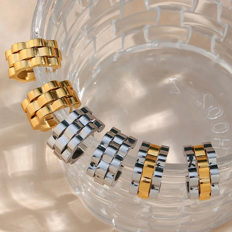 

Introducing our Watchband Hoop Earrings - a unique design that will elevate any look. Its small size ensures it will stand out and add a touch of sophistication to your outfit. With these earrings, you&